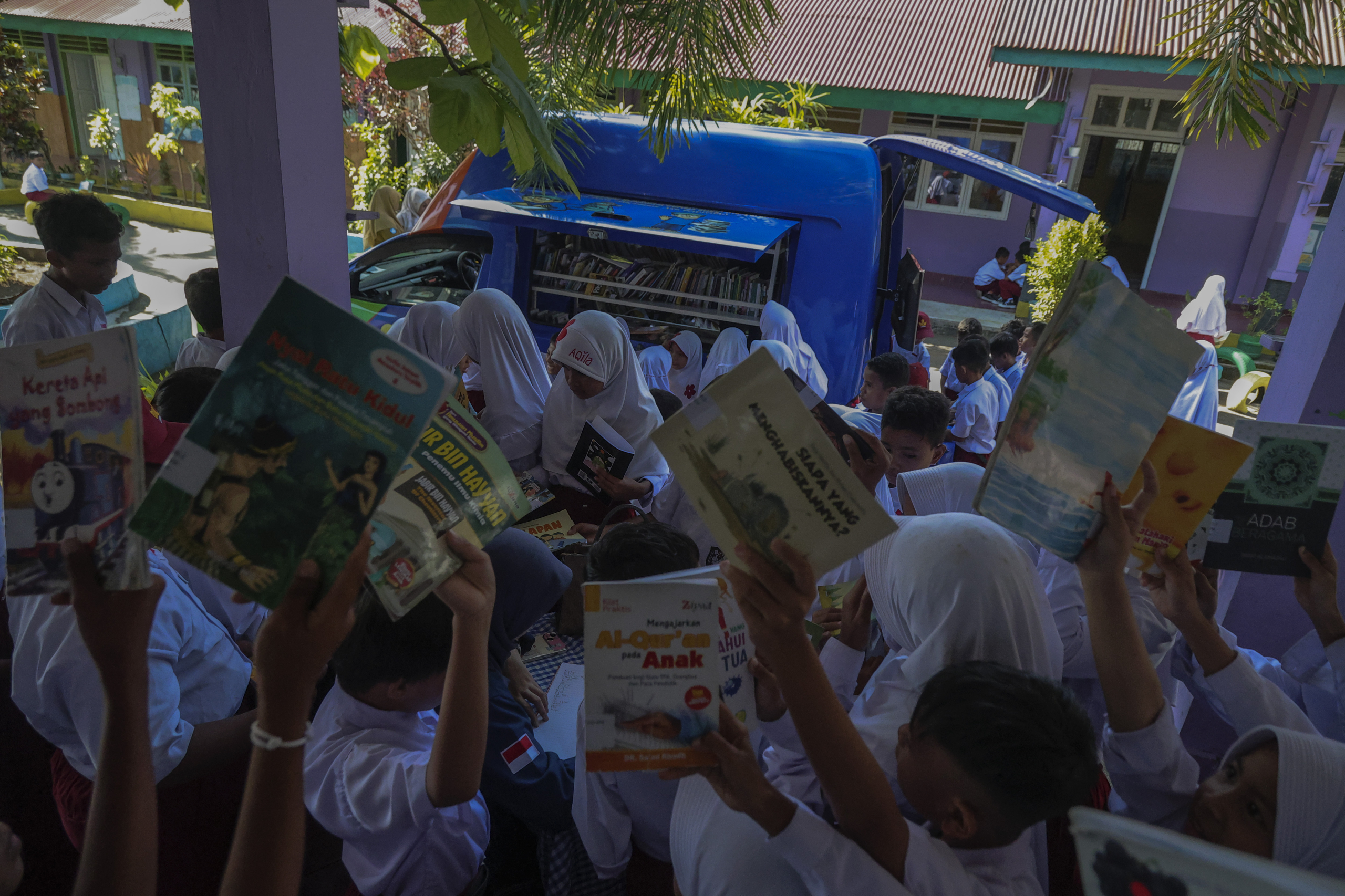 Petugas mendata para siswa yang mengambil buku bacaan yang disediakan Mobil perpustakaan keliling di SD Negeri 50 Kota Ternate, Maluku Utara, Selasa (30/9/2025).Dinas Kearsipan dan Perpustakaan (Disarpus) Provinsi Maluku Utara melakukan jemput bola dengan layanan mobil perpustakaan keliling yang digelar rutin di sejumlah sekolah tingkat SD, SMP, hingga SMA sebagai upaya untuk meningkatkan literasi membaca bagi siswa dan berupaya untuk mencapai target di tahun 2025 tingkat gemar membaca 60-70 persen di Maluku Utara.KOKEHE FOTO/ Azzam. 